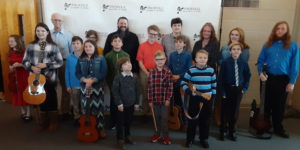 Music instructor Ryan Byrne pictured with his students at Knoxville Academy of Music's 2020 Winter Recital at Concord United Methodist Church in Farragut, TN.