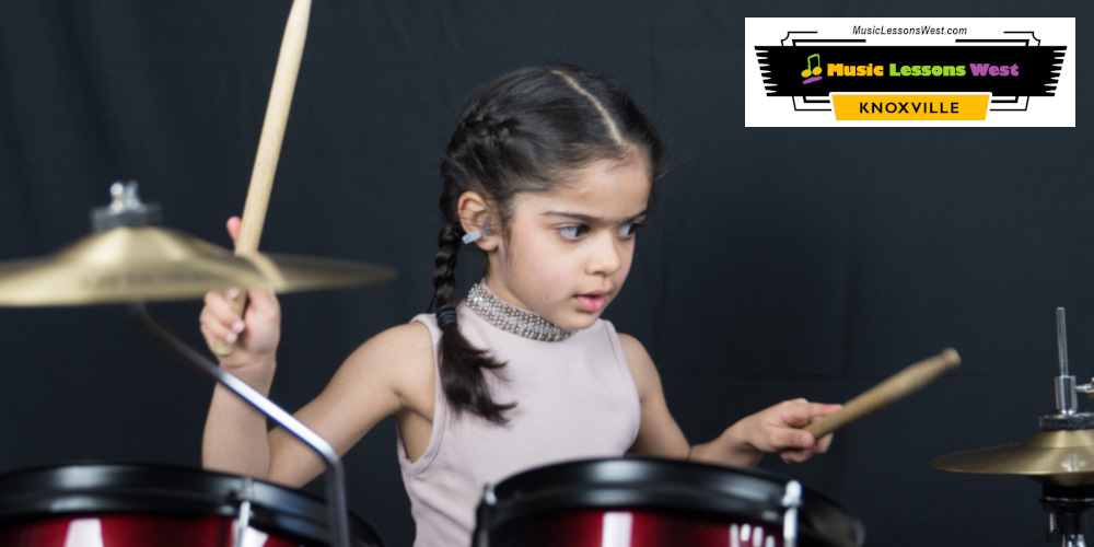 Featured image for Drum Lessons page on MusicLessonsWest.com depicting young girl playing the drum set.
